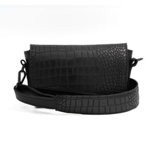 Kép betöltése a galériamegjelenítőbe: A black leather crossbody bag with a textured surface and an adjustable strap, displayed in an open position to show the interior compartment.
